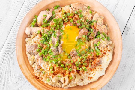 Photo for Oyakodon Japanese bowl dish with chicken, onion, egg and sliced scallion - Royalty Free Image