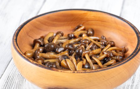Wooden bowl of cooked brown beach mushrooms