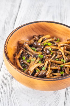 Wooden bowl of cooked brown beach mushrooms