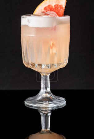 Goblet glass of Grapefruit tequila sour cocktail