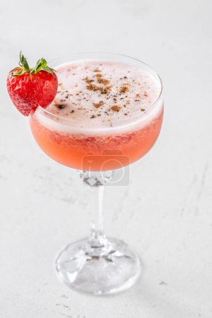Strawberry fields cocktail garnished with balsamic vinegar drops