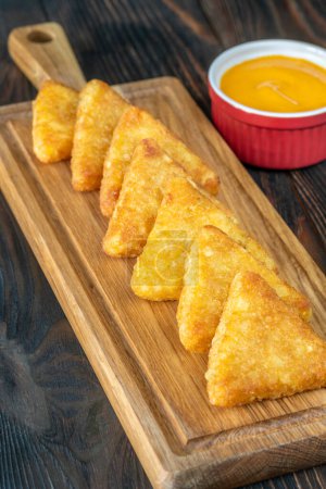 Hash Browns patties with cheddar cheese sauce