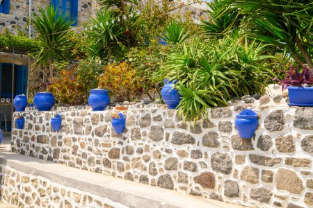 Blue pots at the entrance to a typical Greek house on Nisyros island. Greece