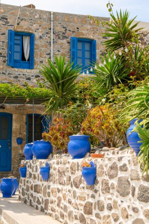 Blue pots at the entrance to a typical Greek house on Nisyros island. Greece