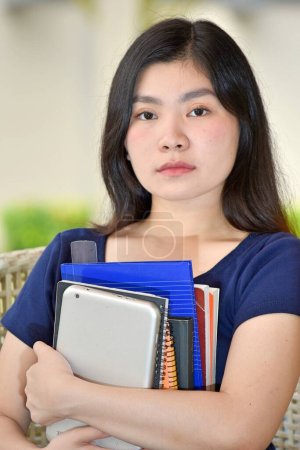 Serious Youthful Minority Person With Notebooks
