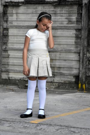 Photo for Young Philippina Preteen And Anxiety Wearing Skirt Near Wall - Royalty Free Image