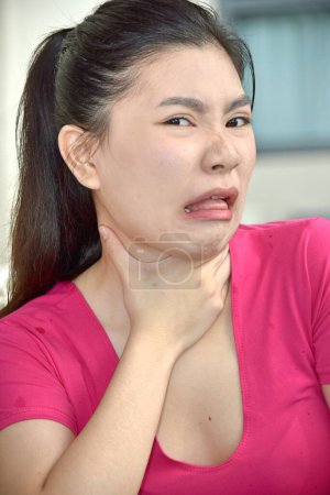 Photo for An Attractive Minority Adult Female Choking - Royalty Free Image
