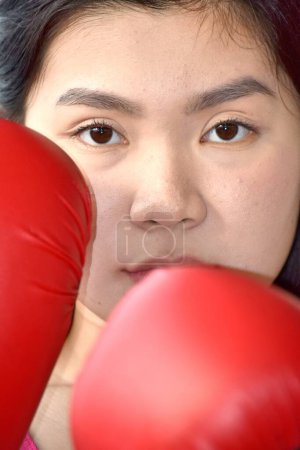 Photo for Serious Chinese Person Wearing Boxing Gloves - Royalty Free Image