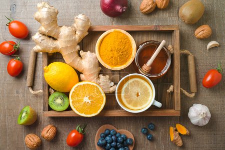 Photo for Immunity boosters friuts and vegetables on wooden table. Health care background concept. Top view, flat lay - Royalty Free Image