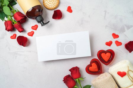 Photo for Valentines day and romantic spa treatment concept. Towels, rose flowers candles and greeting card mock up on bright background. Top view, flat lay - Royalty Free Image