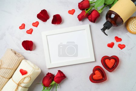 Foto de Valentine's day and romantic spa treatment concept. Mock up frame, rose flowers and candles on bright background. Top view, flat lay - Imagen libre de derechos