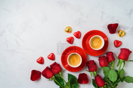 Foto de Valentine's day romantic date concept. Coffee cups, heart shape chocolate and  rose flowers on modern background. Top view. Flat lay - Imagen libre de derechos