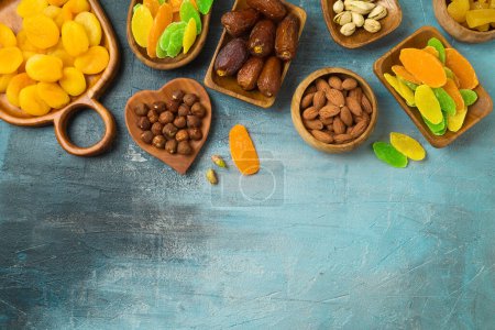 Téléchargez les photos : Dried dates, fruits and nuts on rustic background. tu bishvat holiday concept. Top view, flat lay. - en image libre de droit