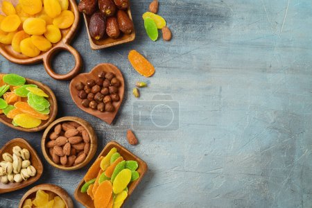 Foto de Dried dates, fruits and nuts on rustic background. Top view, flat lay. - Imagen libre de derechos