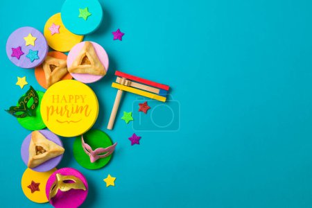 Photo for Purim festival creative border background with carnival mask and traditional cookies on colorful podiums. Top view, flat lay - Royalty Free Image