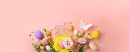 Photo for Easter holiday concept with easter eggs and spring  flowers on pink background. Top view, flat lay - Royalty Free Image