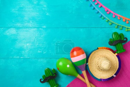 Photo for Mexican party decorations with cactus, maracas and sombrero hat on blue wooden background. Cinco de Mayo holiday celebration. Top view, flat lay - Royalty Free Image
