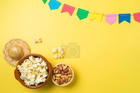 Photo for Brazilian Festa Junina party background with popcorn, peanuts and colorful banners. Top view from above - Royalty Free Image