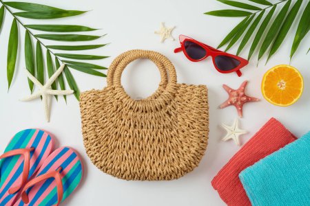 Photo for Summer holiday vacation concept with fashion bag, palm tree leaves and beach accessories on white background. Top view from above - Royalty Free Image