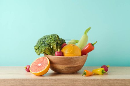 Photo for Summer diet healthy lifestyle concept. Raw vegetables and fruits on wooden table over blue background - Royalty Free Image