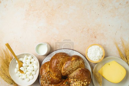 Photo for Jewish holiday Shavuot border background  with challah bread, milk and cheese on stone table. Top view from above - Royalty Free Image