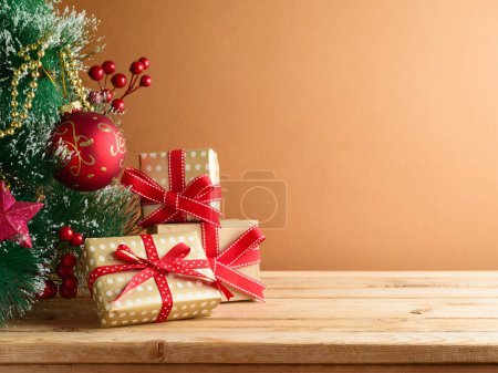Photo for Wooden table with Christmas tree and gift boxes. Background for mock up design and product display - Royalty Free Image