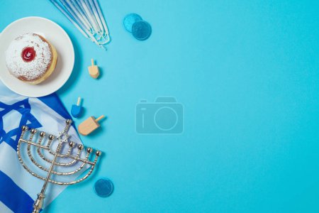 Photo for Jewish holiday Hanukkah concept with traditional donuts, menorah and Israel flag on blue background. Top view, flat lay - Royalty Free Image