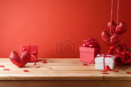 Photo for Valentine's day background with empty wooden table, gift box and heart shapes. Holiday mock up for design and product display - Royalty Free Image