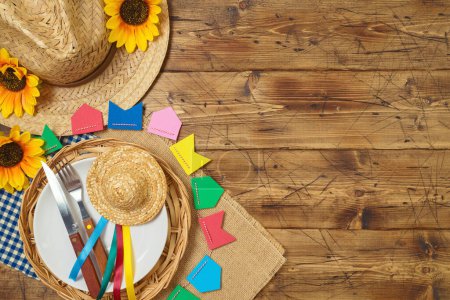 Photo for Festa Junina party table setting with traditional decorations on wooden background. Brazilian summer harvest festival concept. Top view, flat lay - Royalty Free Image