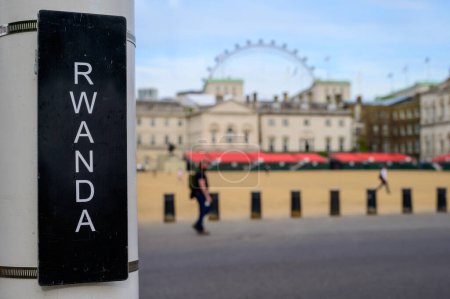 Photo for LONDON - May 18, 2022: Get an up-close view of the Rwanda sign and Jubilee seating at Horse Guards Parade with the London Eye in the background. - Royalty Free Image