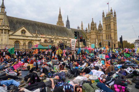Foto de LONDRES - 22 de abril de 2023: Participa en el impactante simulacro de muerte masiva de XR, cuerpos presentados ante el Parlamento, exigiendo justicia climática. - Imagen libre de derechos