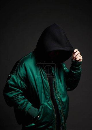 Photo for Stylish Man. Person in Black Hood and bomber jacket. Trendy wear Boy in a hooded sweatshirt - Royalty Free Image