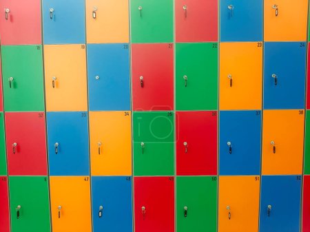 Photo for Lockers of various colors forming a background with the keys in them - Royalty Free Image