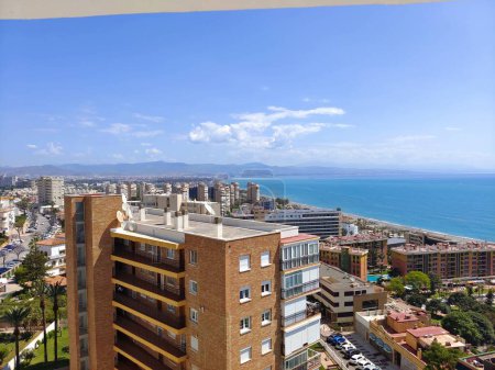 Photo for Torremolinos, Spain - May 2022. PAerial view of spanish city in the coast of Mediterranean sea with the beach in the background in the summer time - Royalty Free Image
