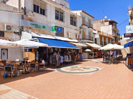 Photo for Torremolinos, Spain - May 2022. People walking in the street with coffee shop side in the summer time. Its a spanish touristic town. - Royalty Free Image