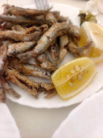 Fried fish with lemon served on a plate