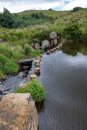 Photo for A stream of fresh water from a spring runs over a weir wall - Royalty Free Image
