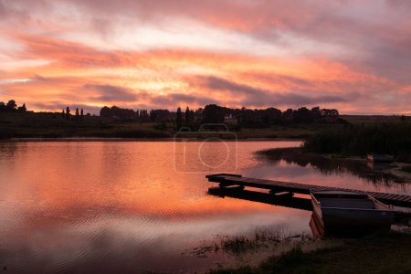 Photo for Striking orange dawn over a dam - Royalty Free Image
