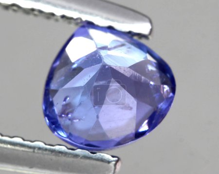 Foto de Natural stone blue sapphire on gray background - Imagen libre de derechos