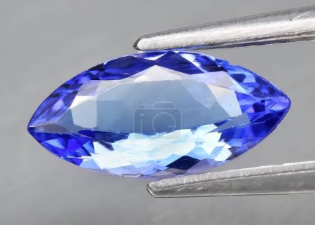Natural gem blue tanzanite on gray background