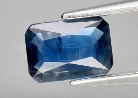 Natural gem blue sapphire on gray background