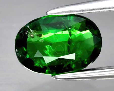 Photo for Natural gem green garnet tsavorite on gray background - Royalty Free Image