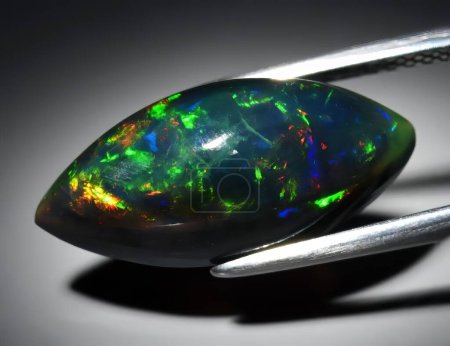 Natural precious stone noble opal on a black background