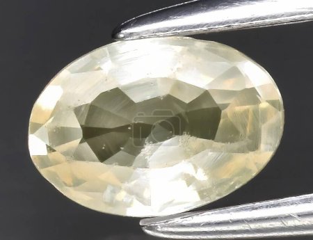 Photo for Natural gem yellow sapphire on gray background - Royalty Free Image