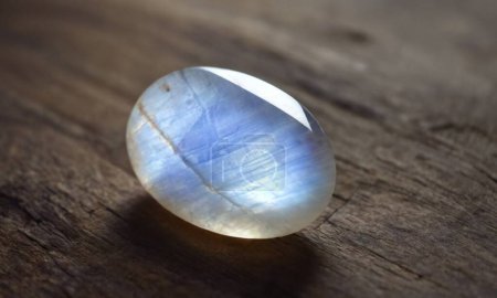 Photo for Natural precious moonstone on a brown background. Natural stone adularia - Royalty Free Image