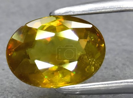 Photo for Natural yellow sphene titanite gem on background - Royalty Free Image