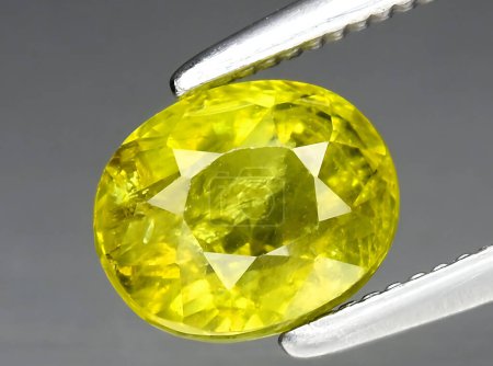 natural yellow grossular garnet gem on background