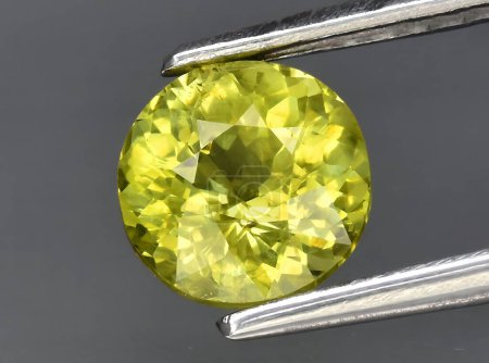 Photo for Natural yellow green grossular garnet gem on background - Royalty Free Image