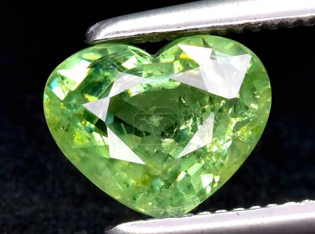 Photo for Natural green demantoid garnet gem on background - Royalty Free Image