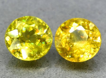 Photo for Natural pair of yellow sphene titanite gem on background - Royalty Free Image